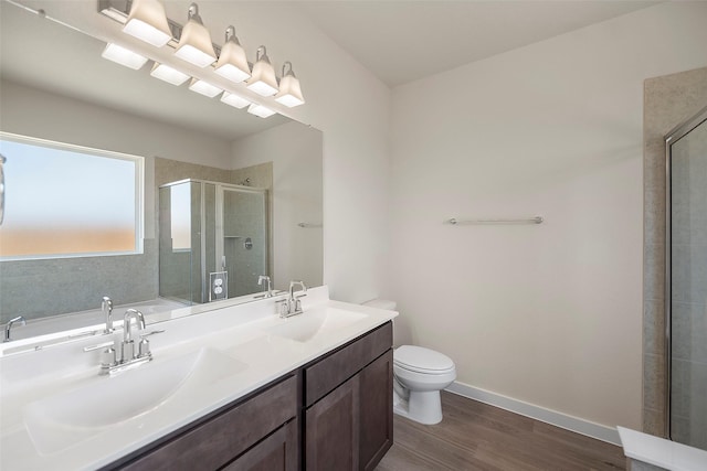 658 Cherry Tree Dr, La Marque, TX 77568 - bathroom with a shower stall, wood finished floors, toilet, double vanity, and baseboards