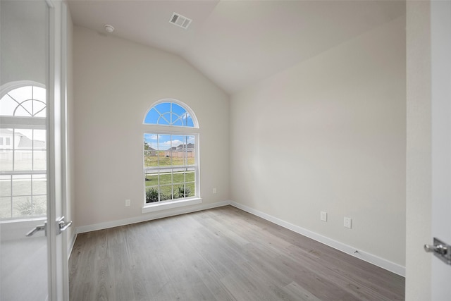 658 Cherry Tree Dr, La Marque, TX 77568 - empty room featuring wood finished floors, lofted ceiling, and baseboards