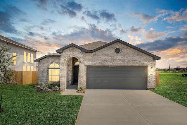 658 Cherry Tree Dr, La Marque, TX 77568 - french country style house featuring brick siding, driveway, and an attached garage