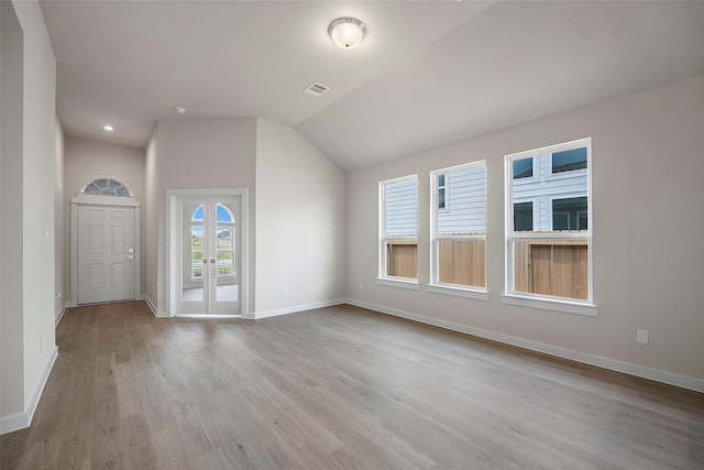 658 Cherry Tree Dr, La Marque, TX 77568 - spare room featuring plenty of natural light, wood finished floors, baseboards, vaulted ceiling, and french doors