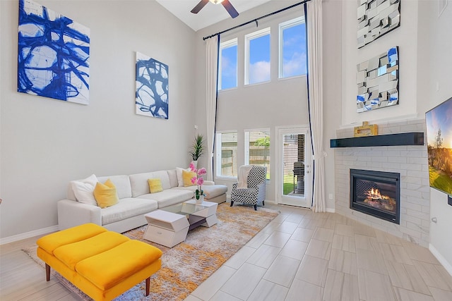 6323 Grand Summit Ct, Katy, TX 77494 - living room with a ceiling fan, a brick fireplace, baseboards, and high vaulted ceiling