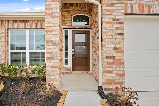 666 Cherry Tree Dr, La Marque, TX 77568 - view of exterior entry featuring brick siding and a garage