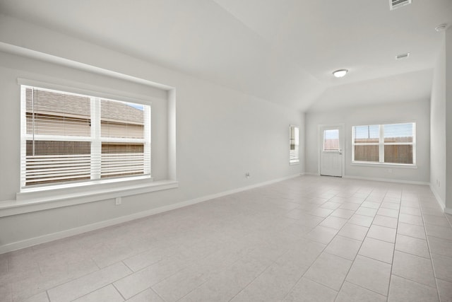 666 Cherry Tree Dr, La Marque, TX 77568 - empty room with light tile patterned floors, baseboards, and lofted ceiling