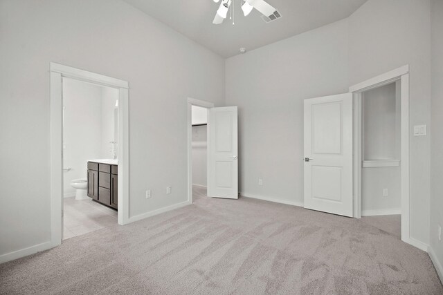 666 Cherry Tree Dr, La Marque, TX 77568 - unfurnished bedroom with light carpet, high vaulted ceiling, a spacious closet, ensuite bathroom, and baseboards