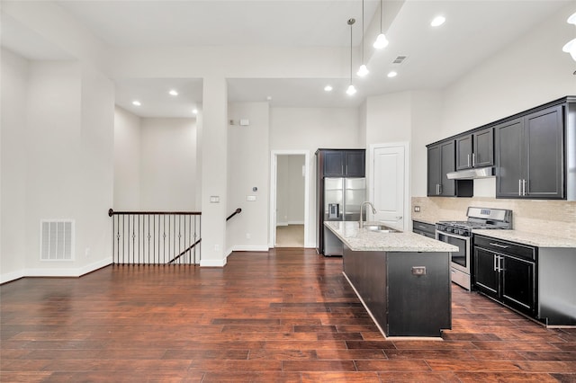 34 N Hutcheson St, Houston, TX 77003 - kitchen featuring stainless steel appliances, a sink, light stone countertops, dark wood-type flooring, and recessed lighting