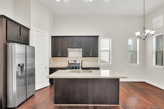 34 N Hutcheson St, Houston, TX 77003 - kitchen featuring appliances with stainless steel finishes, a sink, a chandelier, light stone countertops, and tasteful backsplash