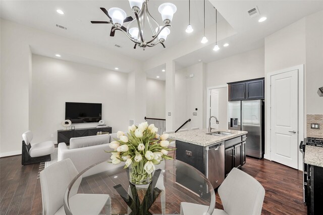 34 N Hutcheson St, Houston, TX 77003 - kitchen featuring stainless steel appliances, a sink, a chandelier, dark wood-style flooring, and recessed lighting