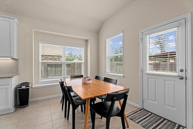635 W Linnwood Dr, Woodbranch, TX 77357 - dining space with baseboards, lofted ceiling, and light tile patterned floors