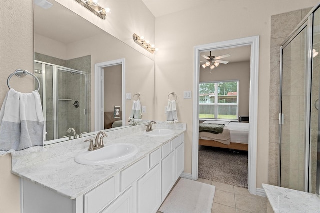 635 W Linnwood Dr, Woodbranch, TX 77357 - ensuite bathroom featuring a shower stall, a ceiling fan, tile patterned floors, double vanity, and baseboards