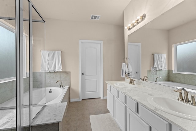 635 W Linnwood Dr, Woodbranch, TX 77357 - bathroom featuring tile patterned floors, a bath, double vanity, and baseboards