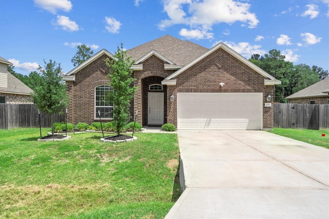 635 W Linnwood Dr, Woodbranch, TX 77357 - view of front of house with brick siding, an attached garage, driveway, and a shingled roof