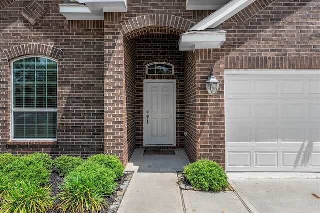 635 W Linnwood Dr, Woodbranch, TX 77357 - view of exterior entry with brick siding and a garage