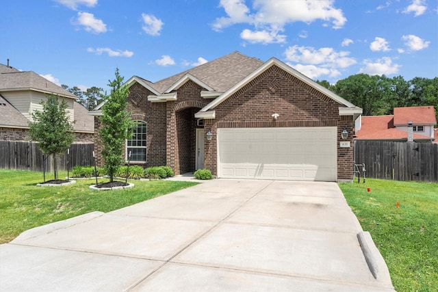 635 W Linnwood Dr, Woodbranch, TX 77357 - traditional-style house with brick siding, an attached garage, concrete driveway, and roof with shingles