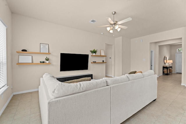 635 W Linnwood Dr, Woodbranch, TX 77357 - living room featuring light tile patterned flooring, ceiling fan, baseboards, and healthy amount of natural light