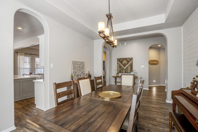 123 Clearmont Pl, Montgomery, TX 77316 - dining space featuring arched walkways, dark wood-type flooring, and baseboards