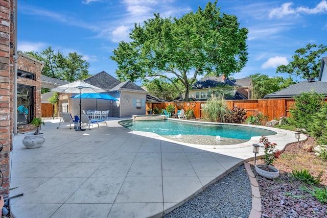 view of swimming pool with a patio, a fenced backyard, and a pool with connected hot tub