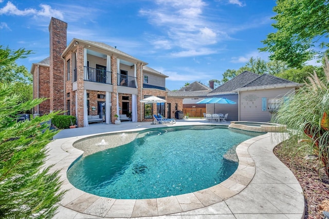 view of pool with a patio, fence, a pool with connected hot tub, and central AC unit