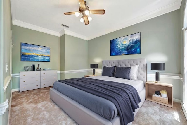 carpeted bedroom with crown molding, ceiling fan, and baseboards