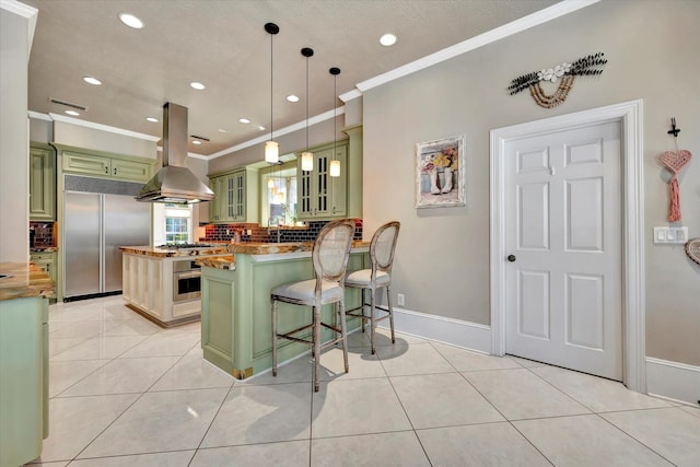 kitchen with green cabinets, island exhaust hood, stainless steel appliances, tasteful backsplash, and ornamental molding