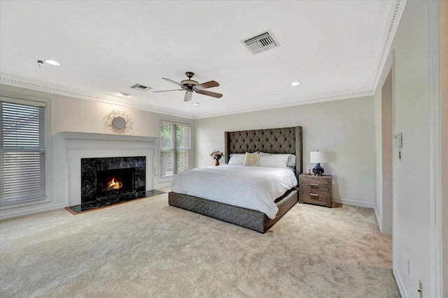 bedroom featuring crown molding, carpet floors, a high end fireplace, ceiling fan, and baseboards