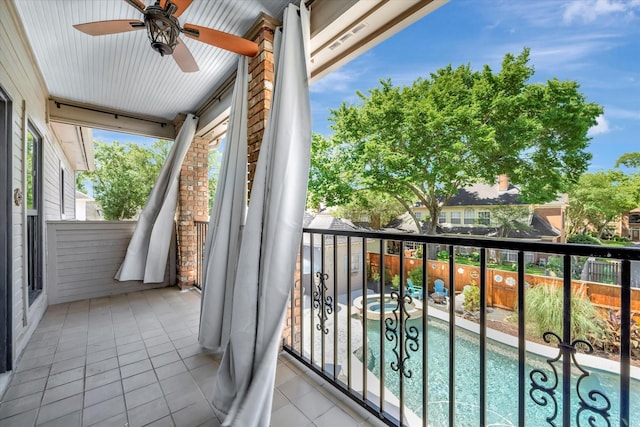 balcony with ceiling fan and view of pool