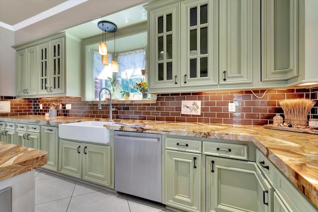 kitchen featuring stainless steel dishwasher, a sink, green cabinets, wood counters, and crown molding