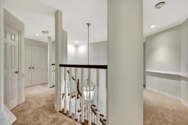 hall featuring carpet, ornamental molding, an upstairs landing, recessed lighting, and baseboards