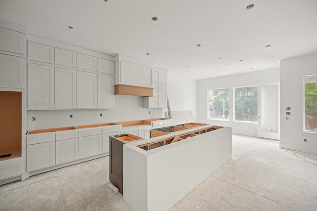 5223 Mimosa Dr, Bellaire, TX 77401 - kitchen with a center island and white cabinetry