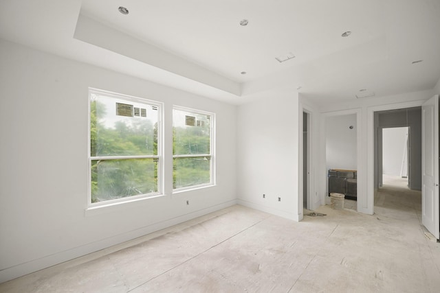 5223 Mimosa Dr, Bellaire, TX 77401 - unfurnished bedroom with multiple windows, a raised ceiling, and baseboards