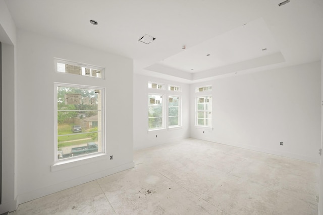 5223 Mimosa Dr, Bellaire, TX 77401 - empty room featuring a raised ceiling, healthy amount of natural light, and baseboards