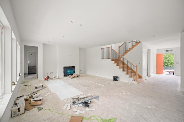 5223 Mimosa Dr, Bellaire, TX 77401 - unfurnished living room with stairway and a glass covered fireplace