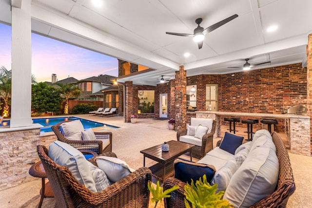 view of patio / terrace featuring outdoor lounge area, exterior bar, ceiling fan, and fence