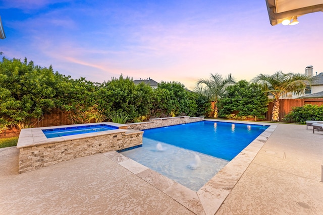 view of swimming pool featuring an in-ground hot tub, a patio area, and a fenced backyard