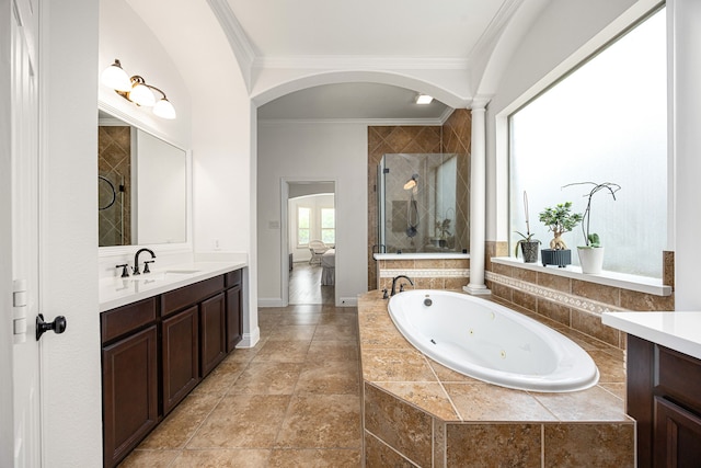 full bathroom with a stall shower, ornamental molding, vanity, a tub with jets, and ornate columns