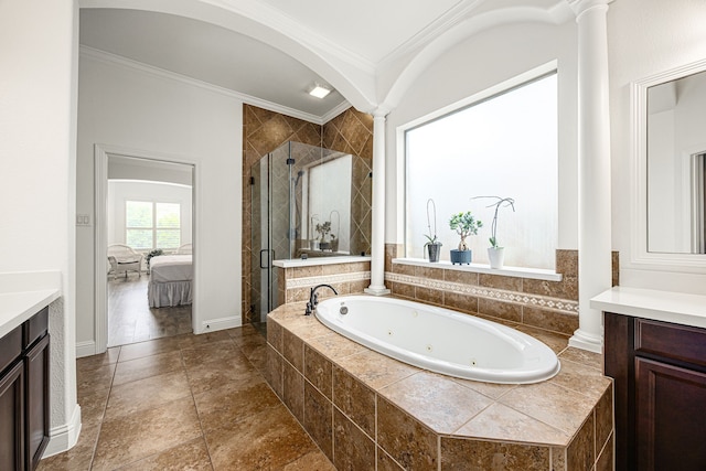 full bathroom with decorative columns, vanity, ornamental molding, a stall shower, and a whirlpool tub