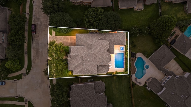 aerial view of property and surrounding area featuring property boundaries highlighted and a pool area