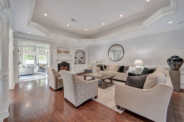 206 Greenbriar Ave, Friendswood, TX 77546 - living room featuring a tray ceiling, a high end fireplace, ornamental molding, dark wood-style floors, and recessed lighting