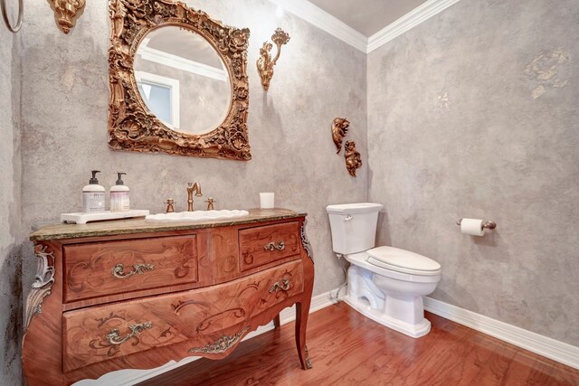 206 Greenbriar Ave, Friendswood, TX 77546 - bathroom featuring wood finished floors, toilet, ornamental molding, vanity, and baseboards