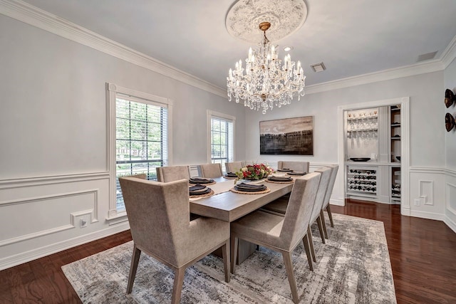 206 Greenbriar Ave, Friendswood, TX 77546 - dining area with a chandelier, ornamental molding, wood finished floors, a decorative wall, and wainscoting
