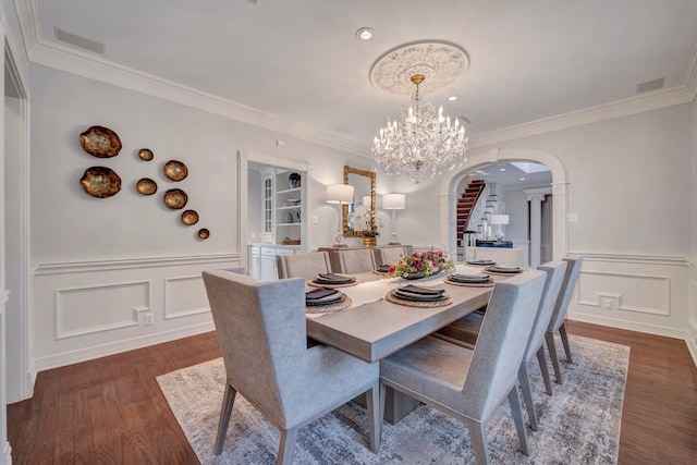 206 Greenbriar Ave, Friendswood, TX 77546 - dining area featuring arched walkways, dark wood-style floors, a decorative wall, a wainscoted wall, and a chandelier