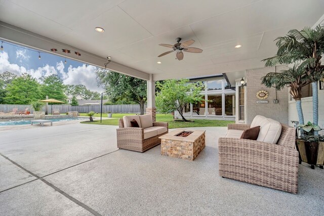 206 Greenbriar Ave, Friendswood, TX 77546 - view of patio / terrace with ceiling fan, a fenced backyard, and an outdoor living space with a fire pit