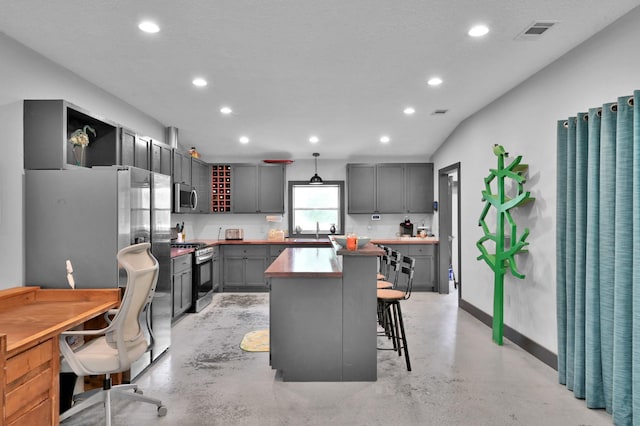 315 Cessna Rd, Trinity, TX 75862 - kitchen featuring appliances with stainless steel finishes, recessed lighting, finished concrete floors, a kitchen bar, and baseboards