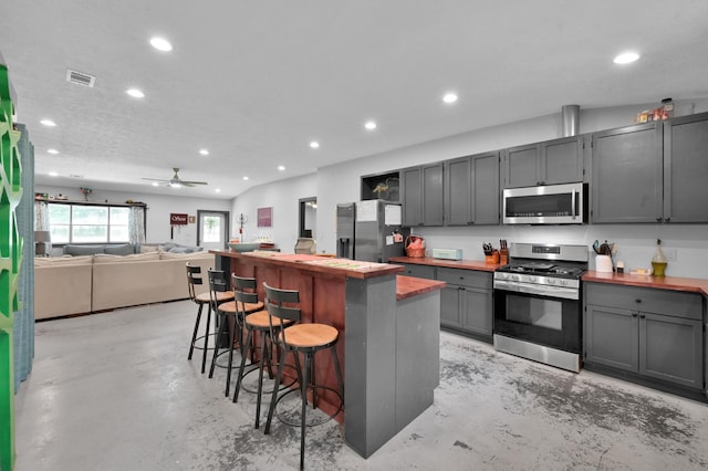 315 Cessna Rd, Trinity, TX 75862 - kitchen with stainless steel appliances, recessed lighting, finished concrete floors, a breakfast bar area, and a ceiling fan