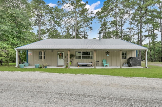 315 Cessna Rd, Trinity, TX 75862 - view of front of house featuring a front lawn, metal roof, and board and batten siding