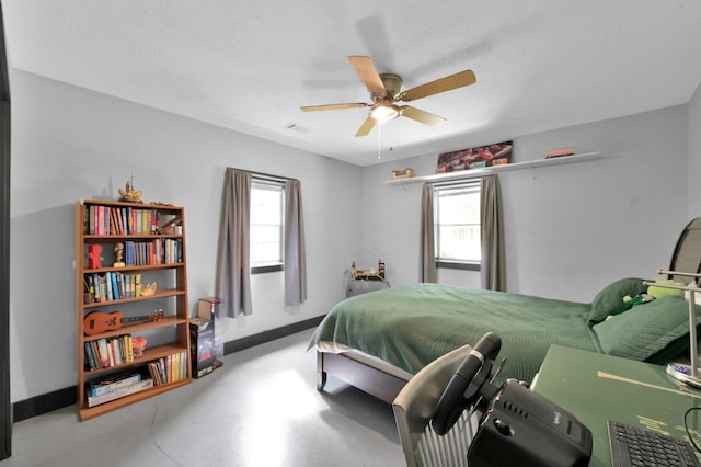 315 Cessna Rd, Trinity, TX 75862 - bedroom with multiple windows, concrete floors, baseboards, and ceiling fan