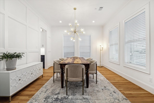 319 E 26th St, Houston, TX 77008 - dining area with a chandelier, light wood finished floors, baseboards, crown molding, and recessed lighting