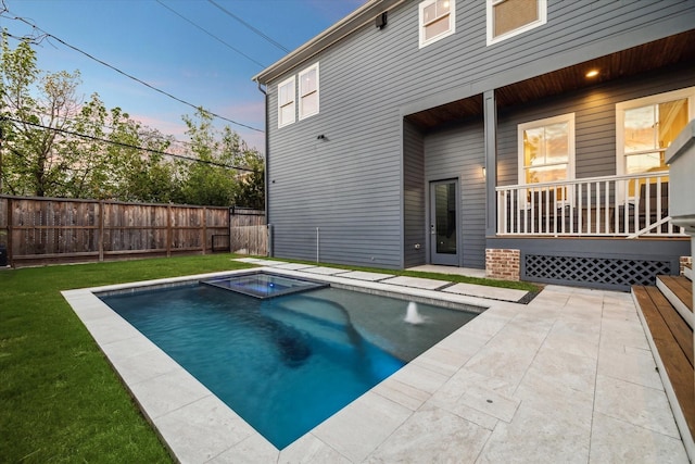 319 E 26th St, Houston, TX 77008 - pool at dusk featuring a pool with connected hot tub and a porch