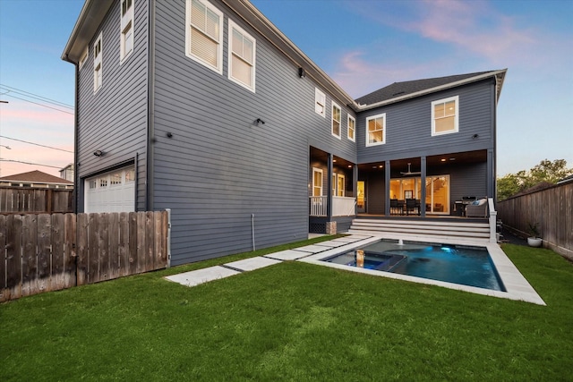 319 E 26th St, Houston, TX 77008 - back of house at dusk with an in-ground hot tub and an attached garage