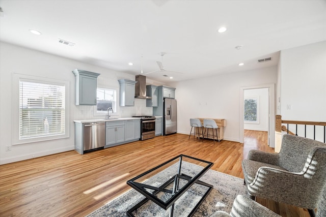 319 E 26th St, Houston, TX 77008 - living room featuring light wood-type flooring, recessed lighting, baseboards, and a ceiling fan