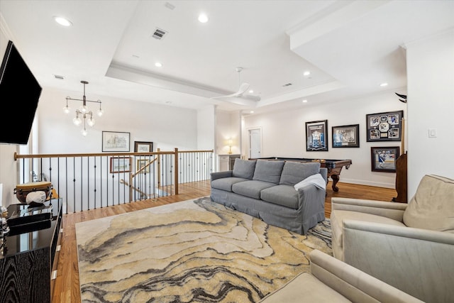 319 E 26th St, Houston, TX 77008 - living room with wood finished floors, a raised ceiling, recessed lighting, baseboards, and crown molding